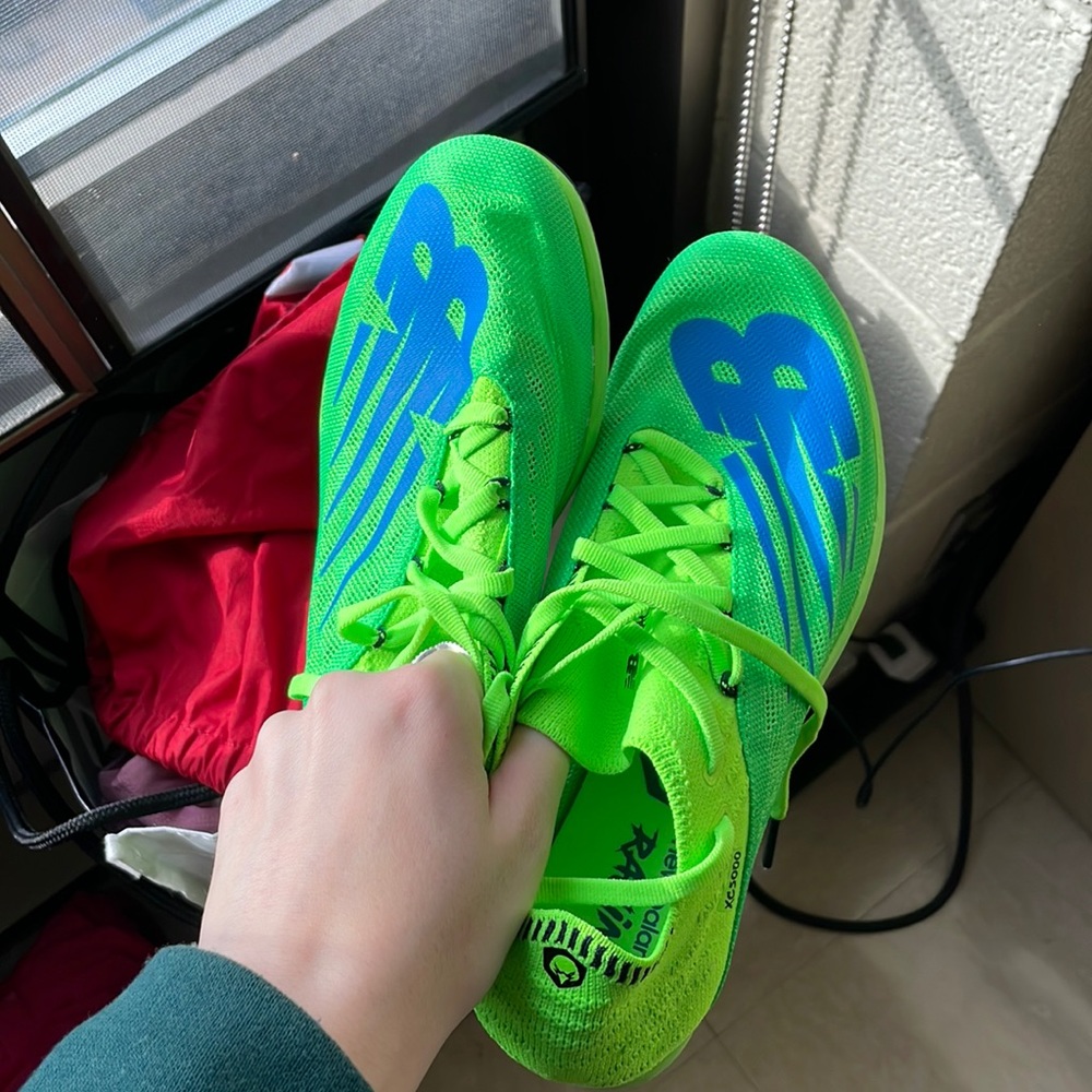brand new, never worn New Balance spikes. women’s 7, men’s 5
